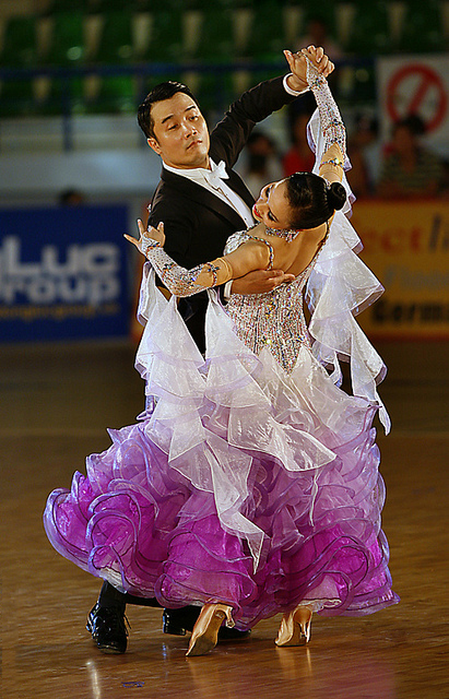 Ballroom dance competitors applying the sway element to their performance
